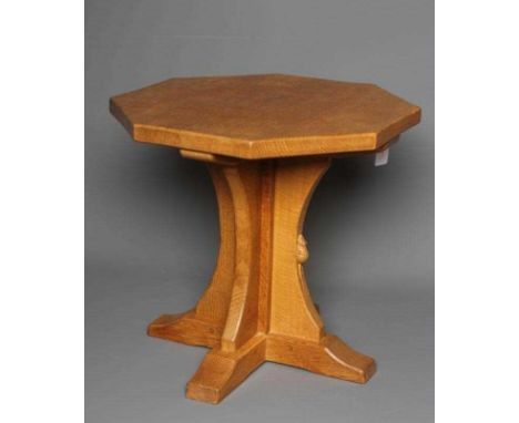 A ROBERT THOMPSON ADZED OAK COFFEE TABLE, the octagonal top with mildly concave sides raised on central cruciform support wit
