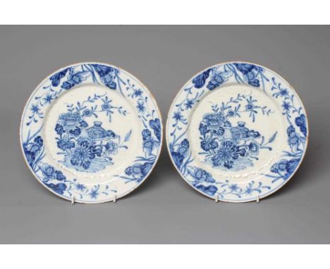 A PAIR OF DELFT PLATES, possibly Lambeth c.1755, of plain circular form centrally painted in blue with a Chinese vase, bound 