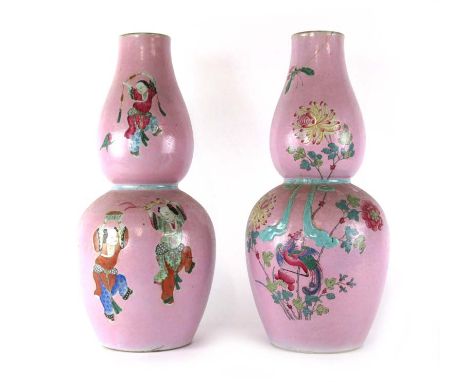 A pair of late 19th/early 20th century Chinese famille rose double gourd vases decorated with natural scenes and dancing figu