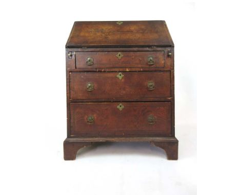 A 19th century burr elm and mahogany crossbanded bureau, the fall front revealing a fitted interior over three long drawers o