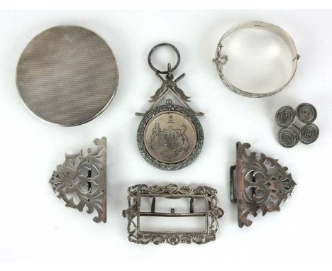 A collection of silver items to include golf medal, buckles, bangle etc. Approx weight 260 grams CONDITION REPORT: Compact A/