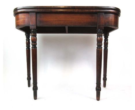 An early 19th century mahogany tea table, the fold over top supported on twin gate action over turned and part ebonised legs,