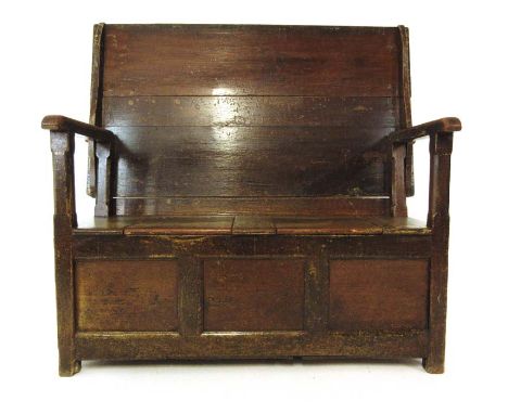 A 19th century painted pine monks bench, the back folding down to create a table over lift up seat storage and a three panele