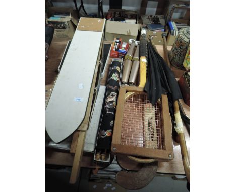 A selection of vintage sports equipment including hockey stick