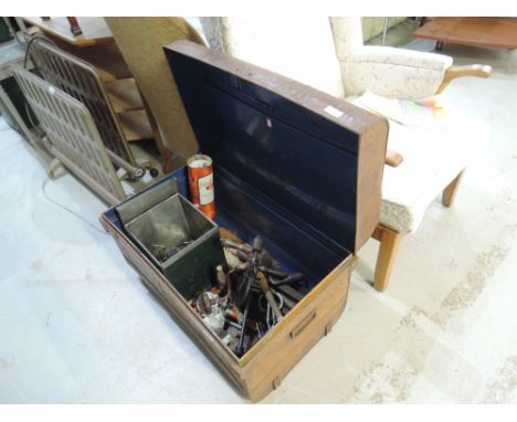 A vintage tin trunk and selection of tools
