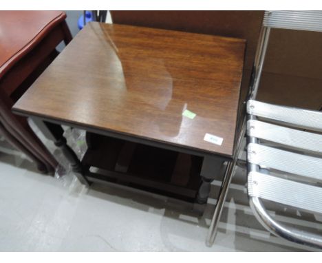 A traditional oak occasional table on casters with book shelf adaptation