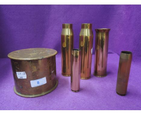 A selection of military ammunition shells including lidded container