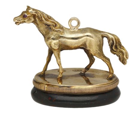 A 19th century gold horse fob seal, the finely cast horse realistically modelled, and mounted to an oval plaque with ribbed b