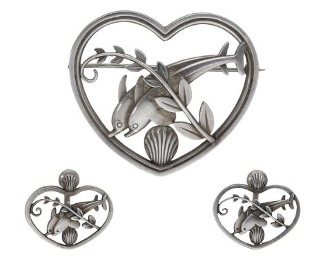 Georg Jensen: a Danish silver leaping dolphins heart-shaped brooch, designed by Arno Malinowski, numbered ‘312’, and a pair o