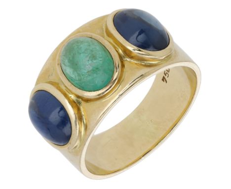 An emerald and sapphire ring, the polished band set with an emerald cabochon with a sapphire cabochon to either side, stamped
