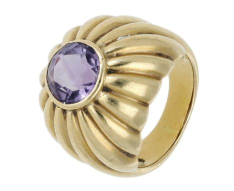 An 18ct gold amethyst set dress ring, of reeded bombé form, collet-set with a circular-cut amethyst, UK hallmarks, ring size 