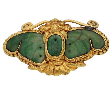 A Chinese jade butterfly brooch, the carved wings and abdomen mounted in a textured gold setting with beaded border, the reve