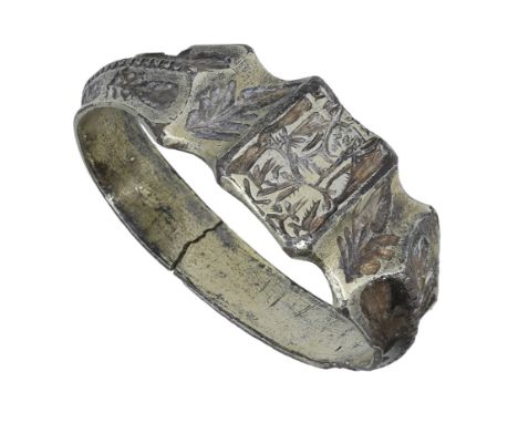 A 15th century silver gilt iconographic ring, the hoop with flat inner section, the moulded ridge above centred with a rectan