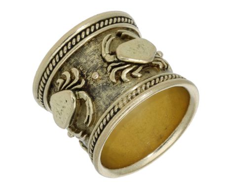 An 18ct gold Zodiac band ring by Elizabeth Gage, 1972, the broad band with crosshatch ground and applied Cancer crab motifs, 