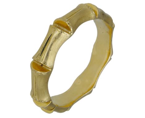 An 18ct gold bamboo style bangle, the stylised bangle of hollow form and with textured finish, hinged, London import mark for