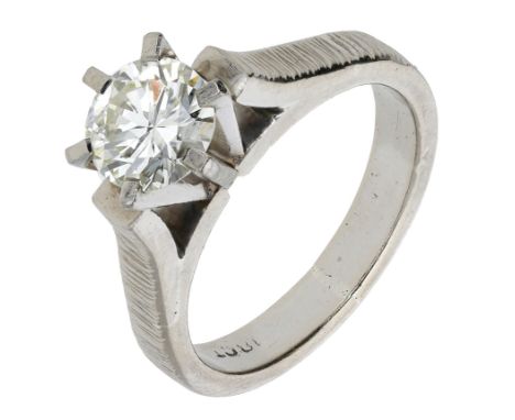 A diamond single stone ring, circa 1970, set with a brilliant-cut diamond in a raised claw setting, between textured shoulder