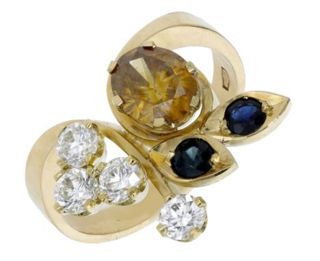 A gem-set dress ring, the stylised foliate spray set with an oval-cut yellow garnet, circular-cut blue sapphires and colourle