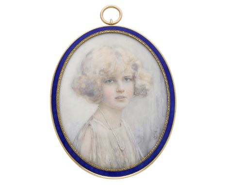 An early 20th century oval glazed portrait miniature, depicting a bust length portrait of a young girl half facing right, wit