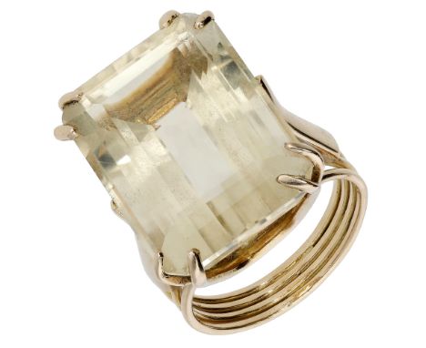 A citrine dress ring, the large step-cut citrine claw-set to a reeded band, the citrine measuring approximately 22 x 11 x 12m