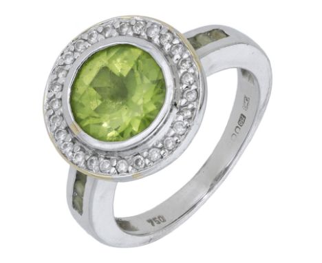 An 18ct white gold peridot and diamond cluster ring, the circular-cut peridot bezel-set within a surround of brilliant-cut di