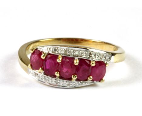 A 9ct yellow gold ruby and diamond set ring, (N).
