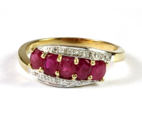 A 9ct yellow gold ruby and diamond set ring, (N).