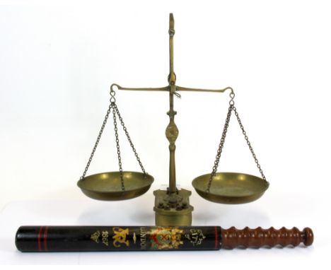 A Victorian style London truncheon and a brass balance scale.