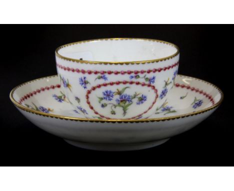 A fine 18th century Sevres porcelain tea bowl and saucer with pink garland and blue floral decoration (possibly a tea cup wit