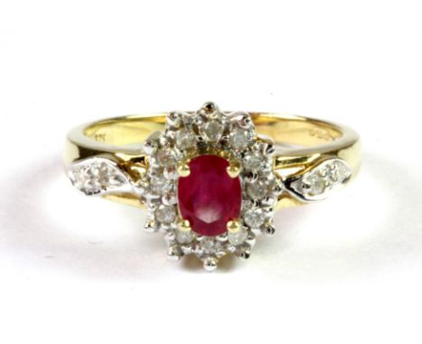 A 9ct yellow gold ruby and diamond cluster ring with diamond set shoulders, (L.5).