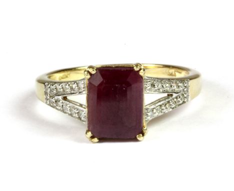 A 9ct yellow gold (stamped 375) ring set with an emerald 2.42ct cut ruby and diamond set shoulders, (P.5).