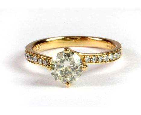 An 18ct yellow gold solitaire ring set with a brilliant cut diamond and diamond set shoulders, (approx. 1ct diamonds overall)