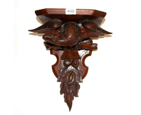 A carved wooden black forest style wall bracket, H. 44cm.