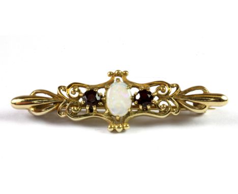 A yellow metal (tested minimum 9ct gold) garnet and opal set brooch, L. 4cm.