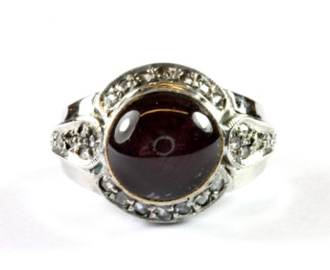 A gentleman's heavy 18ct white gold (stamped 18k) ring set with a cabochon cut ruby and rose cut diamonds, (Q).