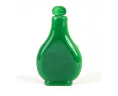 A Chinese carved apple green jade/ hardstone snuff bottle, H. 7cm.