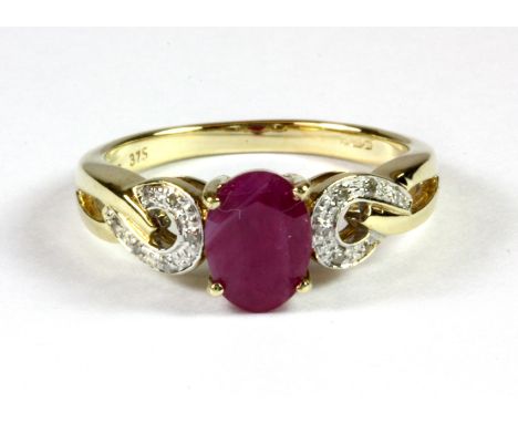 A 9ct yellow gold ruby and diamond set ring, (L.5).