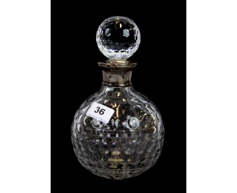 A hallmarked silver mounted cut crystal golf ball decanter.