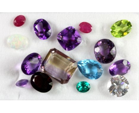 A quantity of mixed gemstones, including ruby, amethyst, topaz, opal, etc.