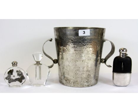 A hammered steel ice bucket, two perfume bottles and a hip flask.