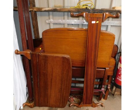 A cast iron framed double bed, mahogany headboard and footboard, together with a cast iron single bed with mahogany headboard