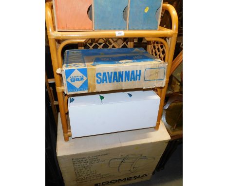 A Domena ironing press, boxed, with instructions, together with a cane and rattan shelf unit, pair of children's storage unit