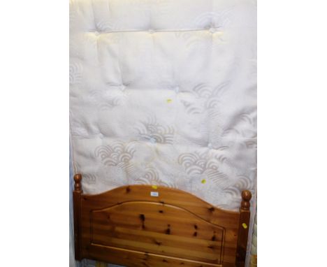 A single divan bed, including a pine headboard.