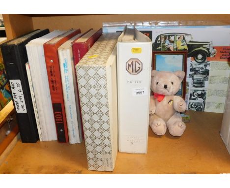 A collection of automobile manuals, covering Austin A99, Austin Cambridge, and MG RV8, together with automobile posters, a sm