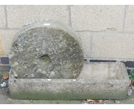 A reconstituted stone trough, together with a small 50cm diameter meal wheel.