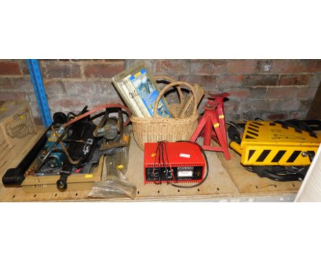 A quantity of car associated tools, including bottle jack, foot pump, battery charger, car clamp Krooklok, a pair of axle sta