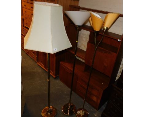A set of three standard lamps, one with traditional shade, uplighter and reading lamp formats, with a polished brass finish.B