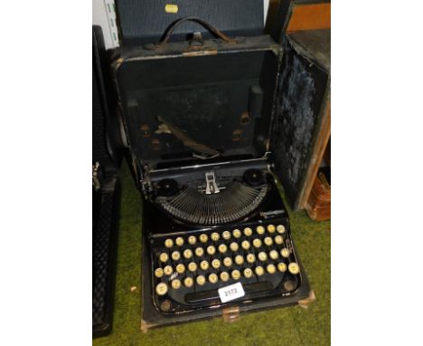 A pair of Remington manual typewriters, cased.