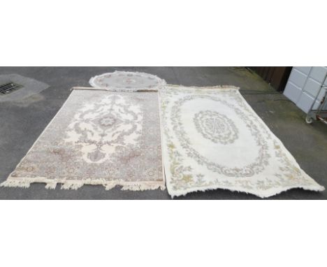 A pair of traditional rugs, one in a light floral pattern, approx 190cm x 300cm, together with a traditional rug in light pas