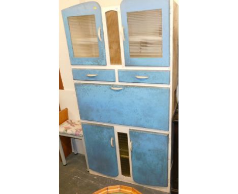 A vintage mid century larder cupboard, in turquoise blue and white, with a pair of perspex fronted doors, over two drawers, a