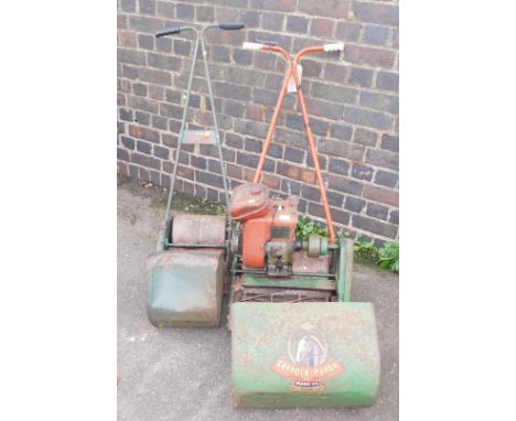 A Suffolk Punch Duel Drive MK7 lawnmower, together with a hand powered lawnmower with roller.